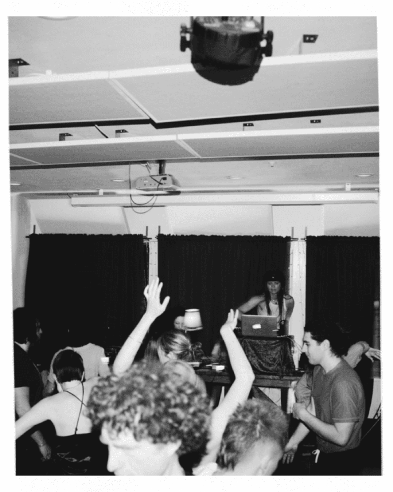Black and white photo of a DJ set and dance floor