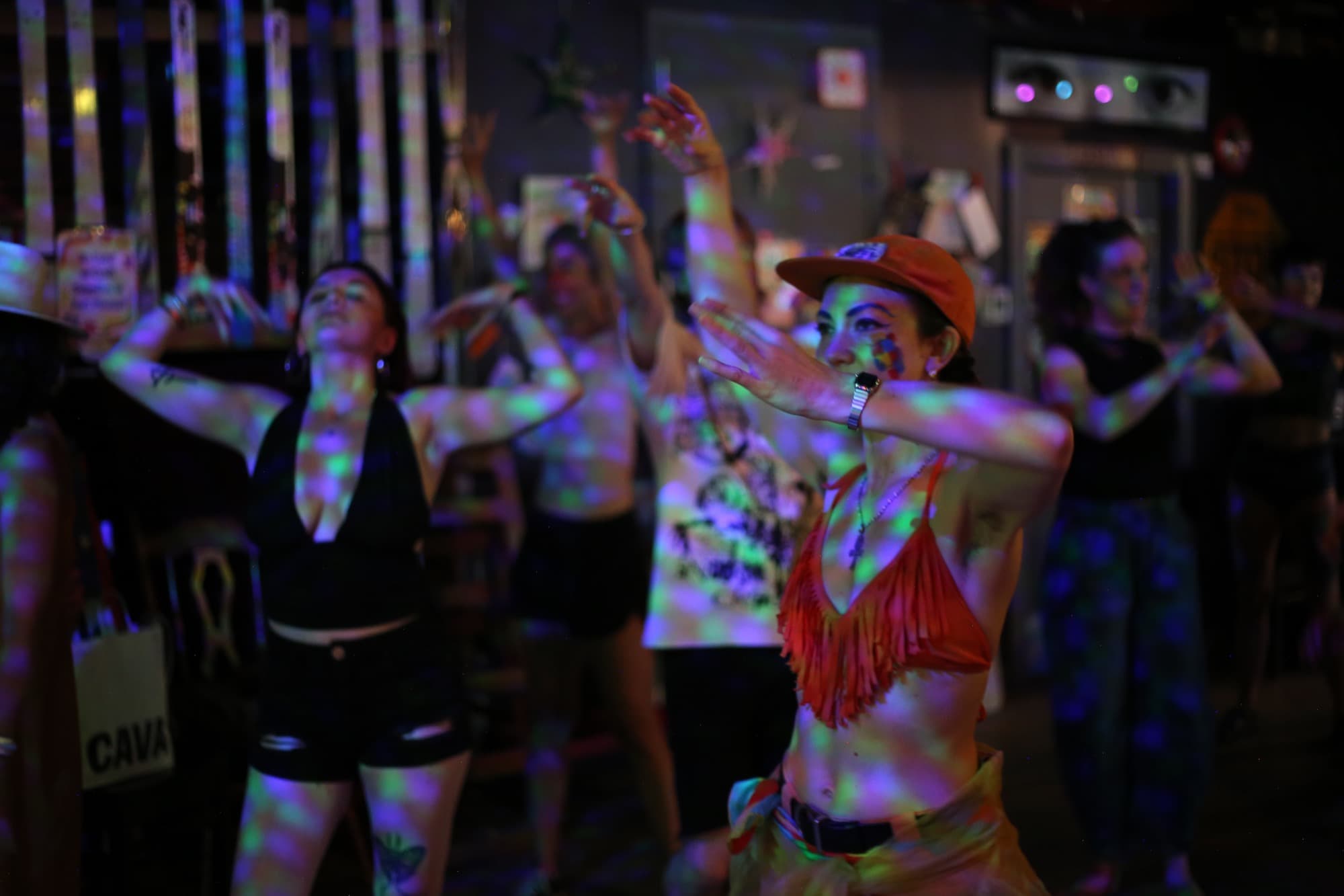 Crowd dancing under colored lights